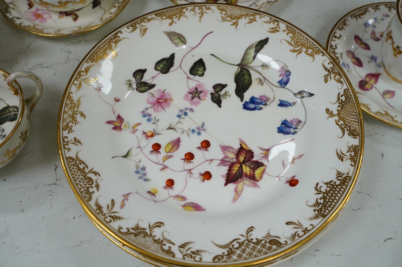 A floral part tea and coffee set, probably Swansea, c.1815-20, largest 23.5cm diameter. Condition - mostly fair